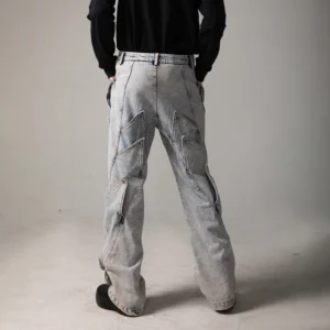 Back view of light blue acid wash baggy jeans featuring shark fin rear panels and a relaxed wide leg silhouette