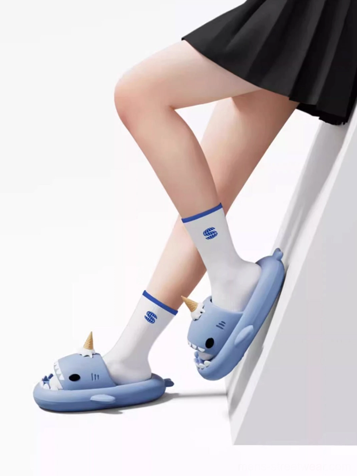 Shark platform slippers worn with white striped socks and casual streetwear outfit in an indoor setting