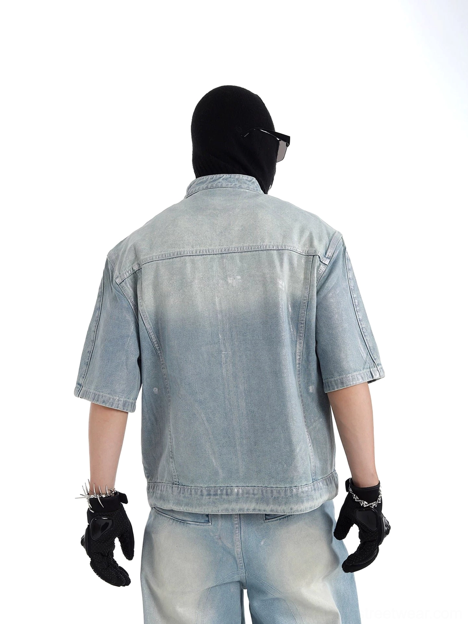 Rear view of short sleeve faded blue denim jacket showing clean back panel, rear yoke seam and relaxed streetwear silhouette