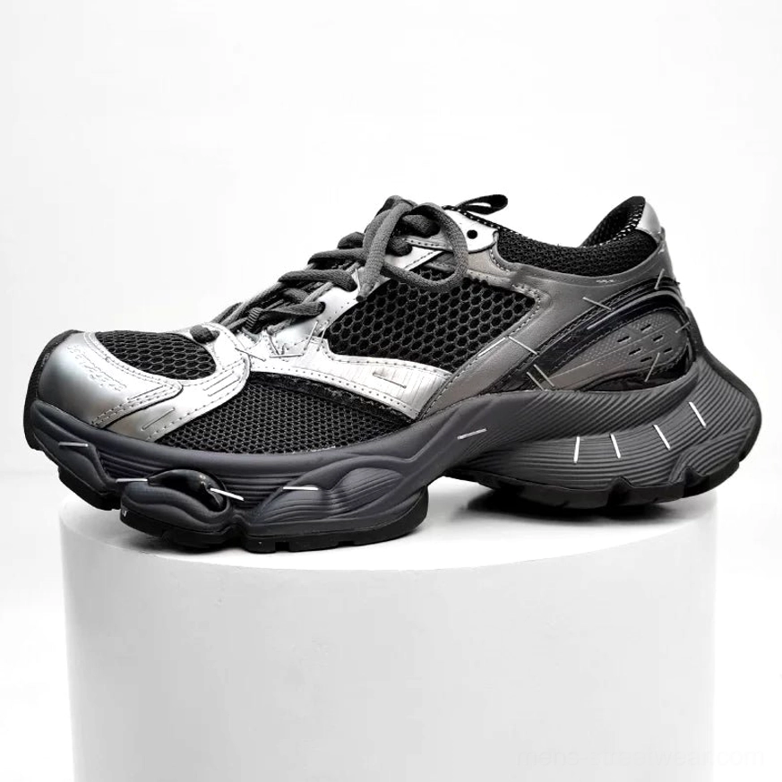 Silver and black chunky mesh sneakers displayed in profile with contrasting panels, breathable ventilation sections, and rugged thick streetwear outsole