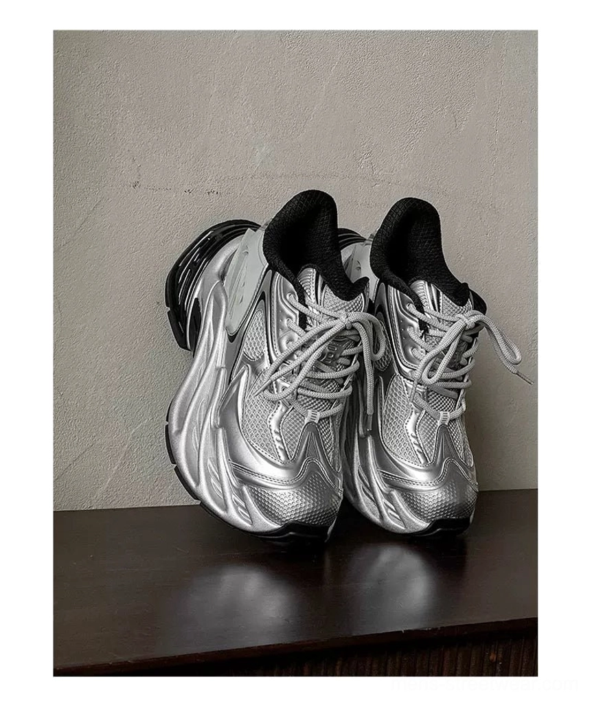 Side view of silver and black futuristic platform runner sneakers with mesh upper and thick black outsole