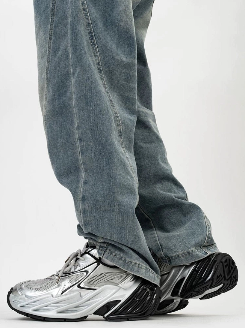 Silver and black futuristic platform sneakers shown from the side with metallic glossy panels, breathable mesh sections, chunky wave-textured rubber outsole, and casual baggy denim styling