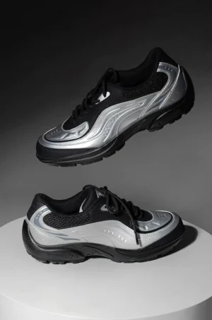 Pair of silver black futuristic running sneakers displayed from top and side views with streamlined wave overlays and padded collars