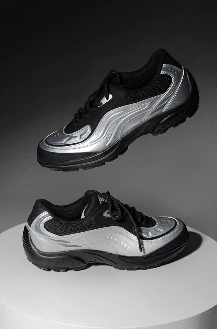 Pair of silver black futuristic running sneakers displayed from top and side views with streamlined wave overlays and padded collars