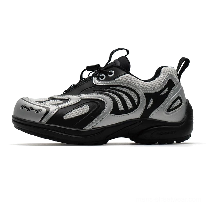 Silver black techwear mesh runner sneakers shown in a left side profile on a white studio background with breathable mesh panels, futuristic layered overlays, and a chunky rubber sole