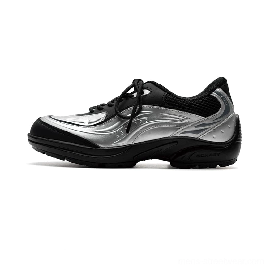 Side profile of a silver black wave runner sneaker featuring flame-inspired metallic patterns, black mesh heel panel, and chunky rubber TPU outsole