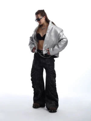 Silver cropped studded moto jacket styled with black wide-leg pants in futuristic streetwear outfit