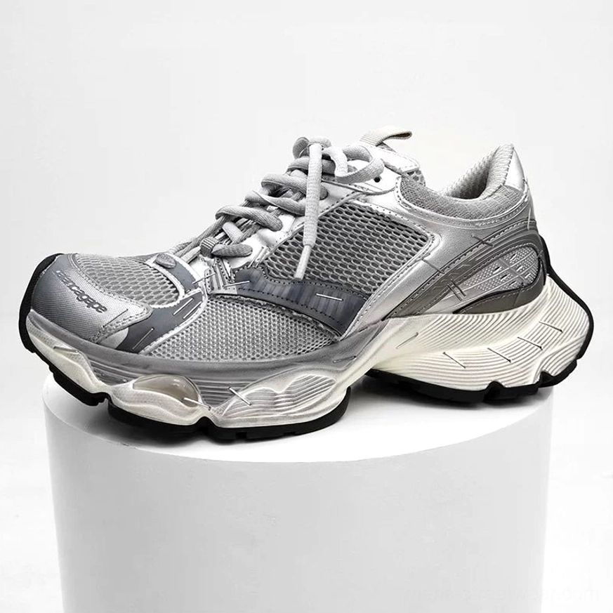 Silver and light grey chunky sneakers shown in side profile with two-tone layered upper, breathable mesh panels, and thick off-white retro sole