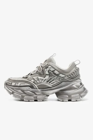 Silver grey platform sneaker side profile showing layered technical upper block heel rear pull tab and rugged outsole