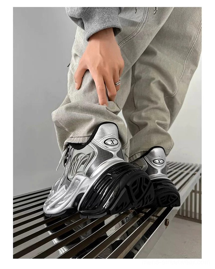 Silver metallic dad runner sneakers with dimensional side structures and oversized wave-sculpted platform sole