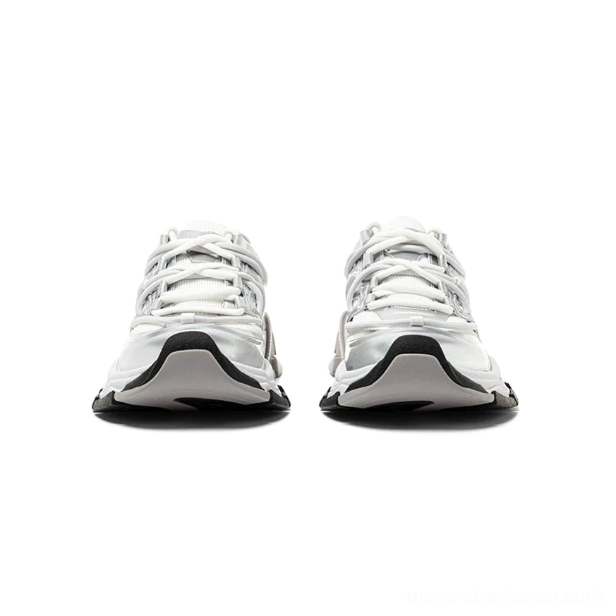 Front view of silver panel chunky sneakers with black rubber toe cap, layered mesh upper, and flat lace-up closure
