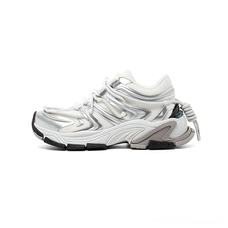 Full side profile of silver white chunky runner sneaker with sculpted overlays, elevated midsole, metallic toe detail, and rear pull tab