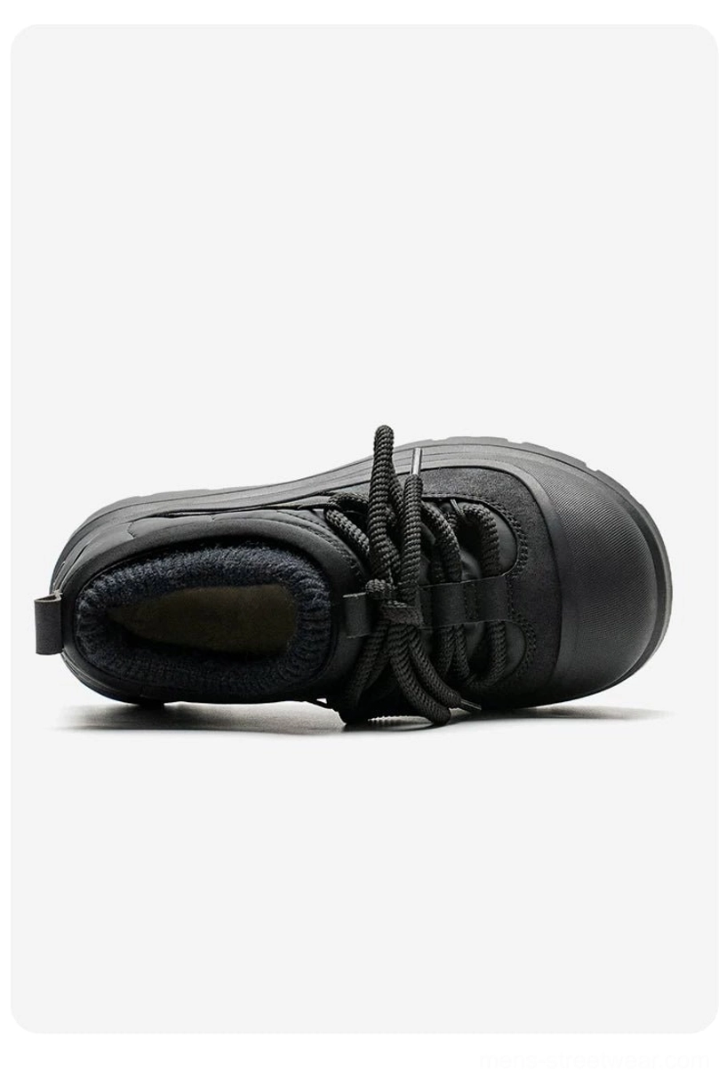 Single black platform sneaker viewed from above showing the fuzzy fleece interior, lace-up upper, rounded toe, and deep rubber outsole