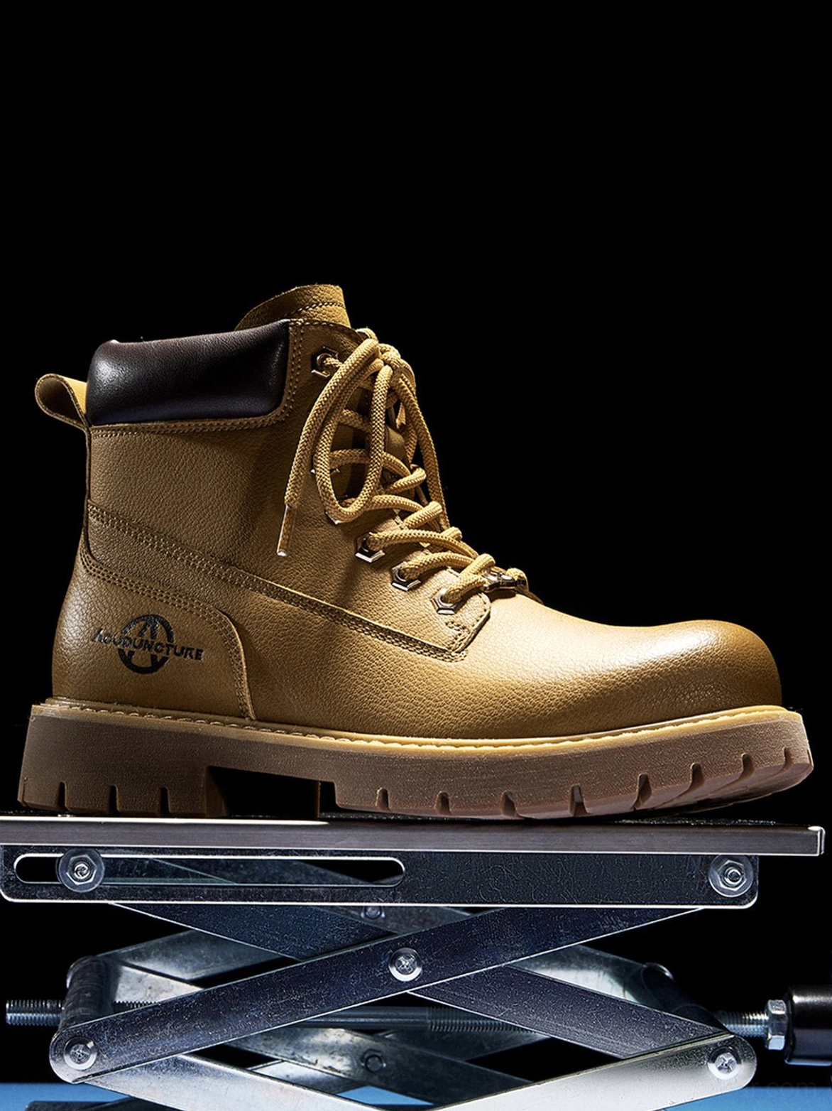 Single wheat yellow work ankle boot featuring dark collar trim, rear pull tab, laces, and thick lug outsole