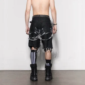 Rear view of black skeleton cutout denim jorts showing frayed rib-inspired back details, raw uneven hems, and oversized streetwear fit