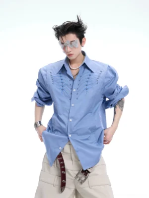 Blue ribcage embroidered long sleeve button-up shirt with relaxed Korean streetwear fit styled with beige wide-leg pants
