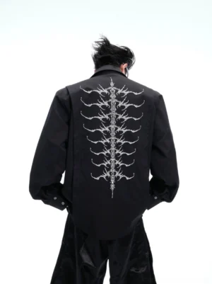 Black spinal skeleton embroidered long sleeve button-up shirt showing large back embroidery and loose streetwear silhouette