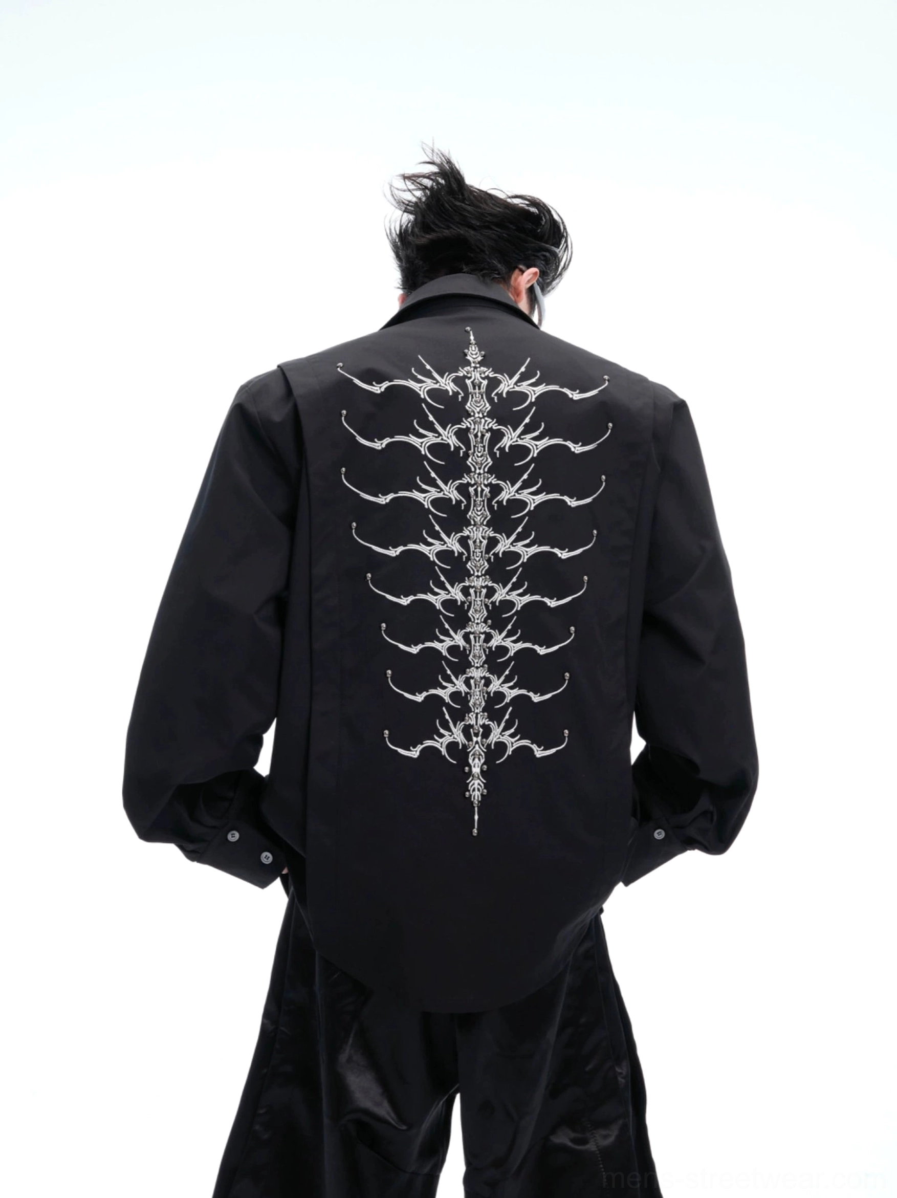 Black spinal skeleton embroidered long sleeve button-up shirt showing large back embroidery and loose streetwear silhouette