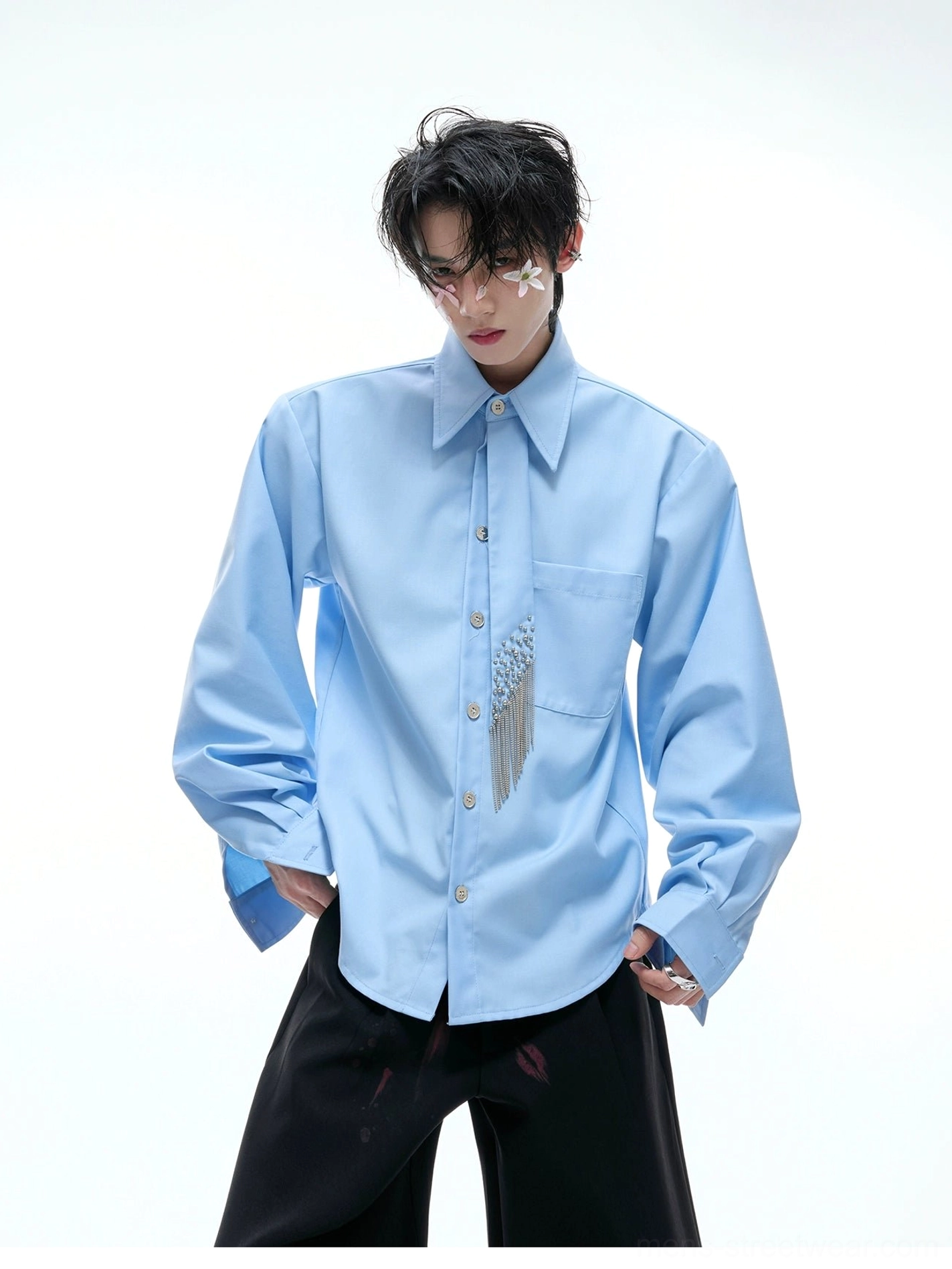 Sky blue oversized crystal tassel shirt with statement pointed collar, metal buttons, chest pocket, and sparkling fringe detail styled with black wide-leg trousers