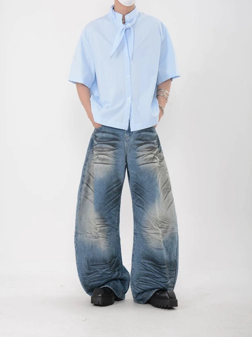 Sky blue short sleeve stand collar shirt with relaxed straight hem, attached bow tie detail, washed jeans, and platform shoes