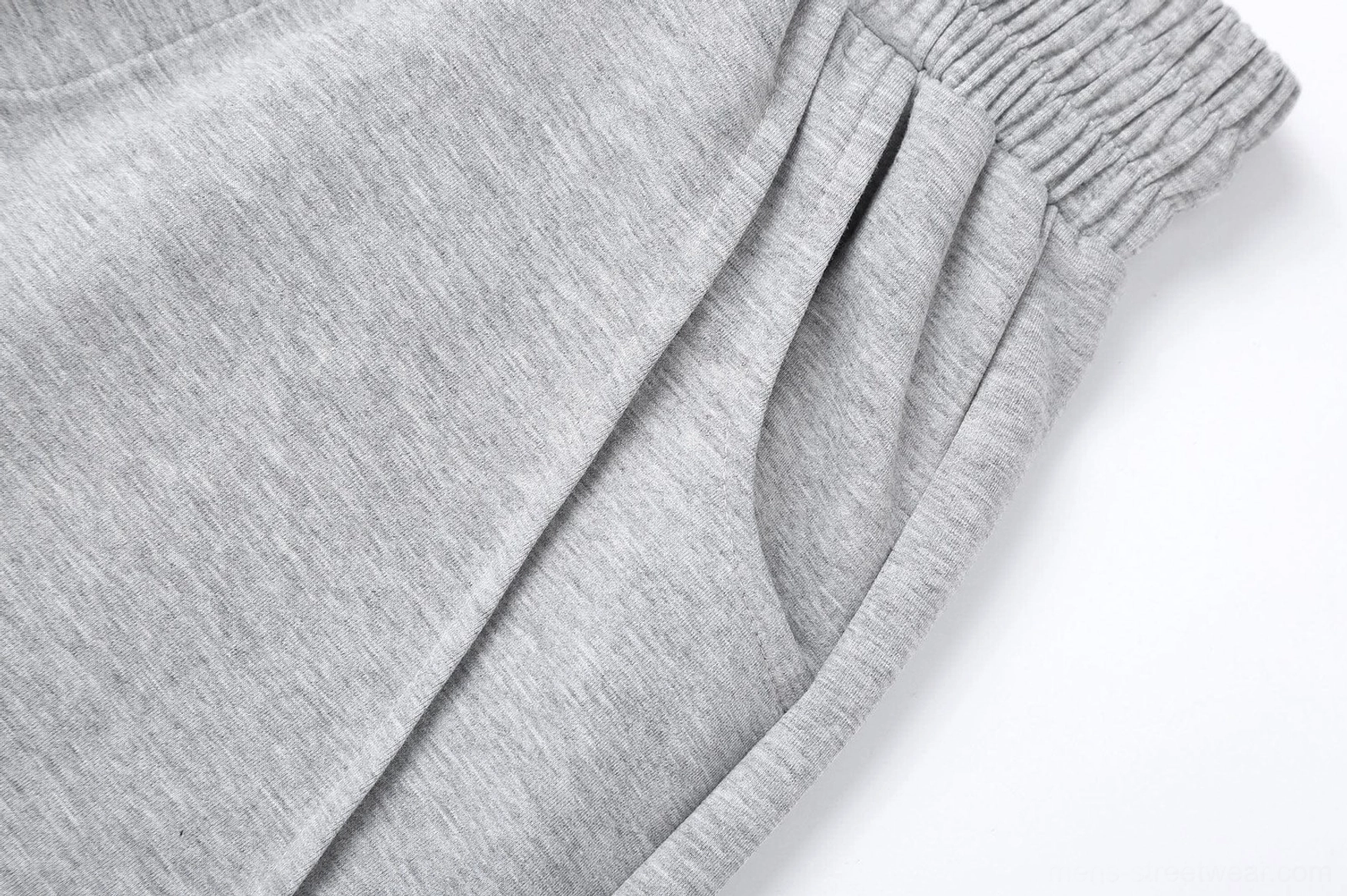 Slanted spliced wide-leg sweatpants in modern Asian streetwear style with adjustable elastic drawstring waist