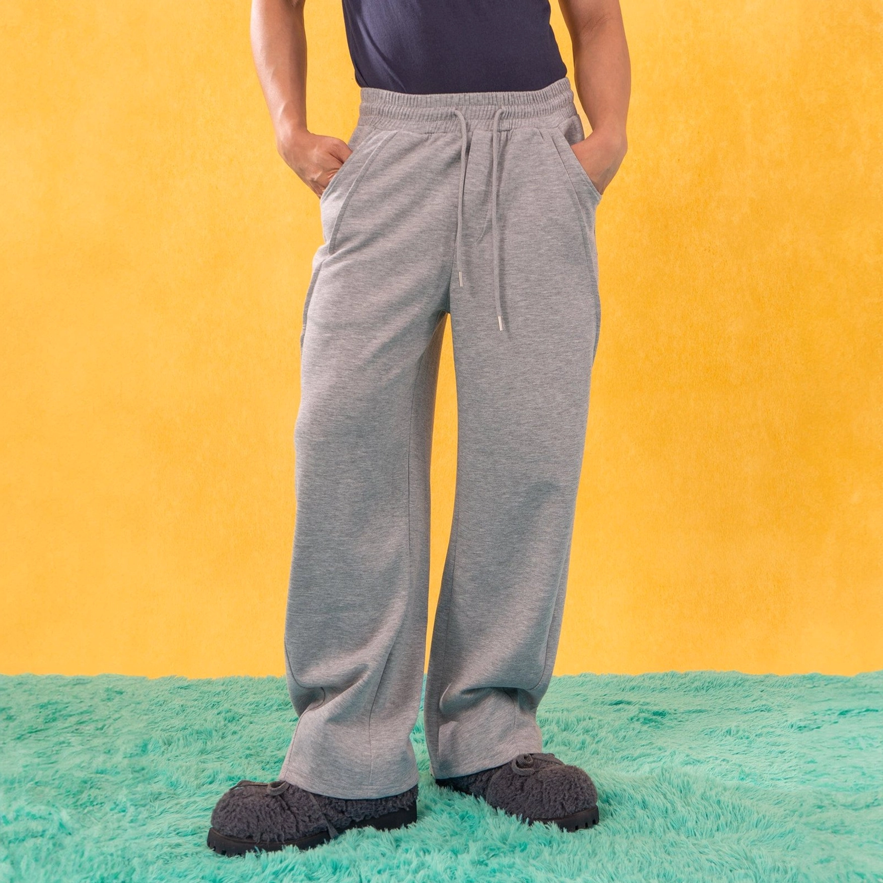 Heather gray slanted spliced wide-leg sweatpants shown from the front with elastic drawstring waist and relaxed Korean streetwear fit
