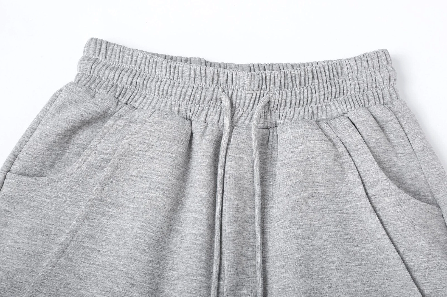 Slanted spliced wide-leg Korean streetwear sweatpants product image showing relaxed silhouette and contemporary panel design