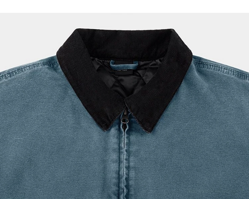 Slate blue two-tone cotton canvas work jacket close-up with black corduroy pointed collar and centered metal zipper