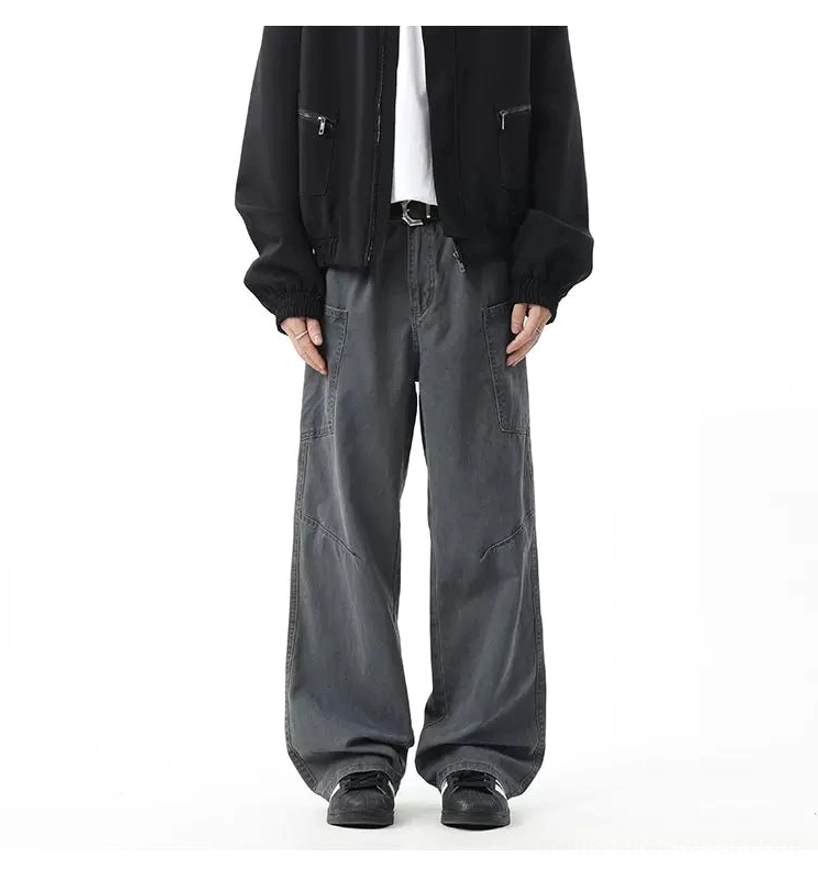 Neutral slate grey baggy wide-leg cargo trousers with belt loops, seam details, black zip jacket, and white tee