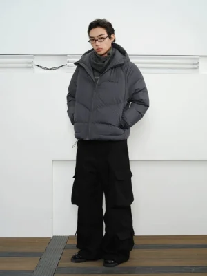 Slate grey chevron quilted hooded down puffer jacket worn with black cargo pants in full front studio view