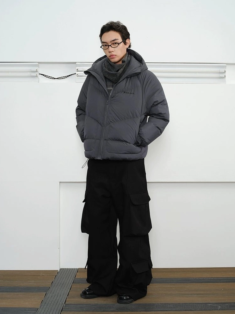 Slate grey chevron quilted hooded down puffer jacket worn with black cargo pants in full front studio view