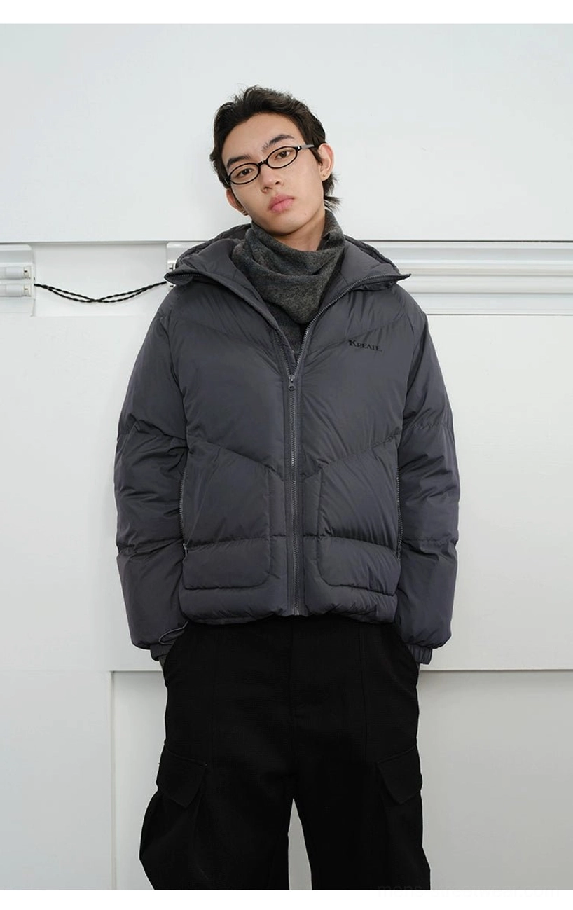 Close-up of slate grey chevron quilted hooded puffer jacket with high stand collar and full front zipper