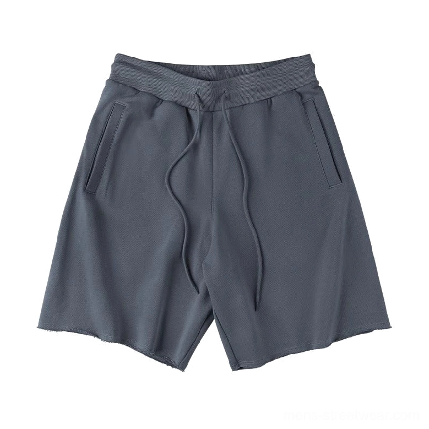 Dark slate grey drawstring sweat shorts flat lay longer drawstrings side pockets raw cut hems neutral streetwear casual shorts