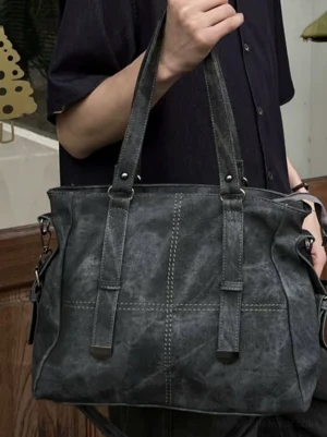 Slate vintage panel tote bag front close-up showing washed faux leather texture, structured panels, stitching, and metal hardware