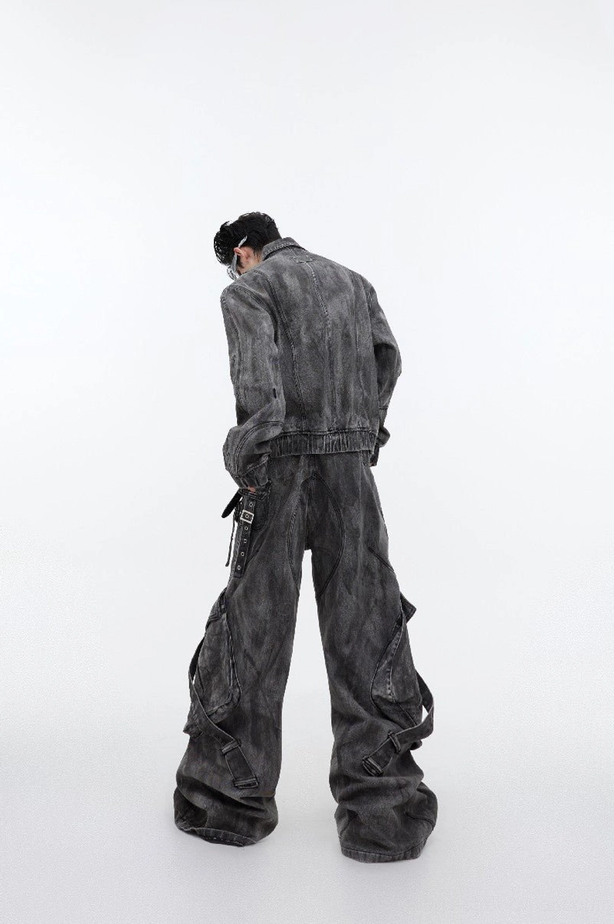 Back view of smoked gray distressed utility denim jacket showing ribbed hem and relaxed cropped streetwear silhouette
