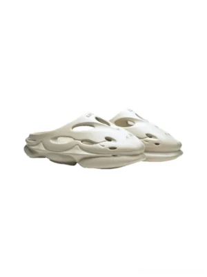 Cream Snow Lion perforated platform clogs shown from a front three quarter view with wave cutouts and chunky dual density sole