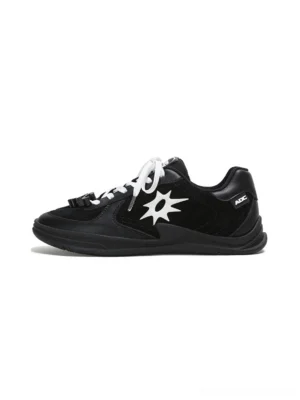 Black solar star applique leather court sneaker with white laces and decorative lace charms shown from the left side