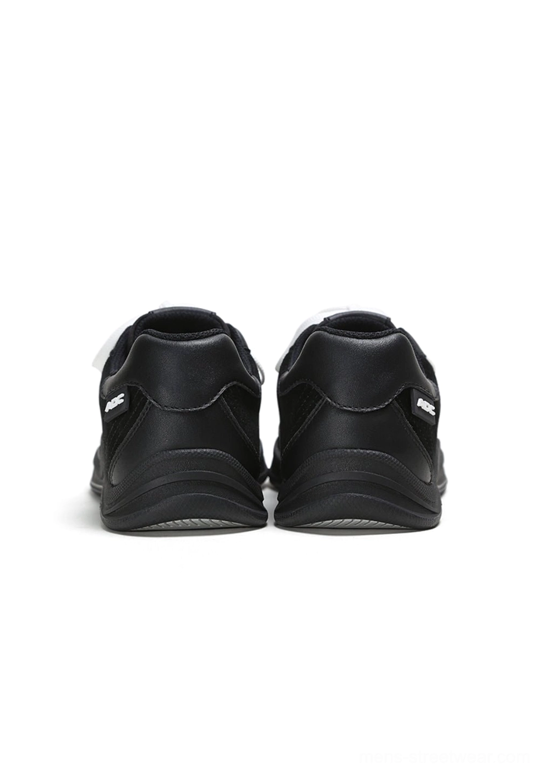 Rear view of black and white solar star applique court sneakers showing the structured heel counters