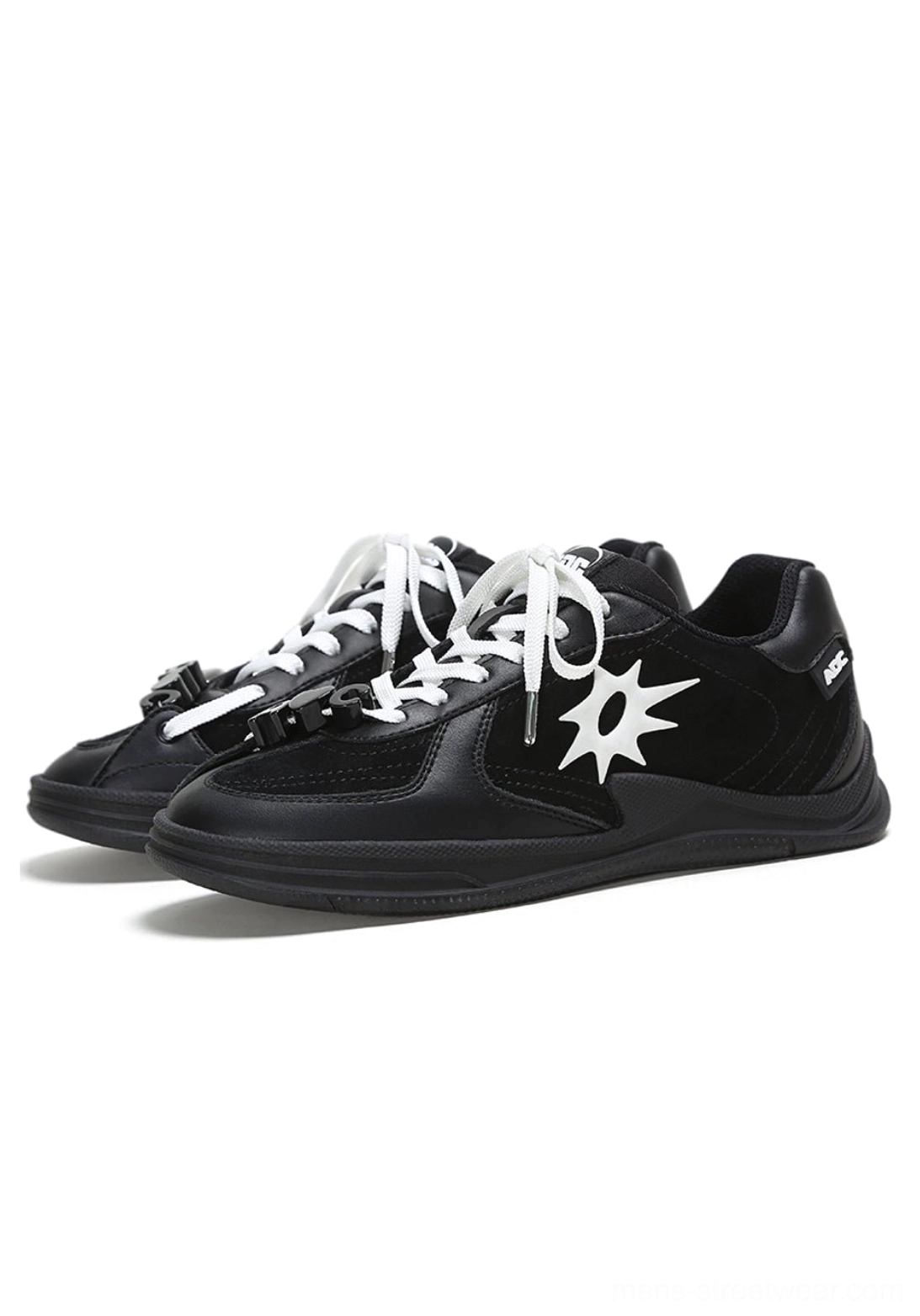 Pair of black and white solar star applique leather court sneakers displayed from a three-quarter angle