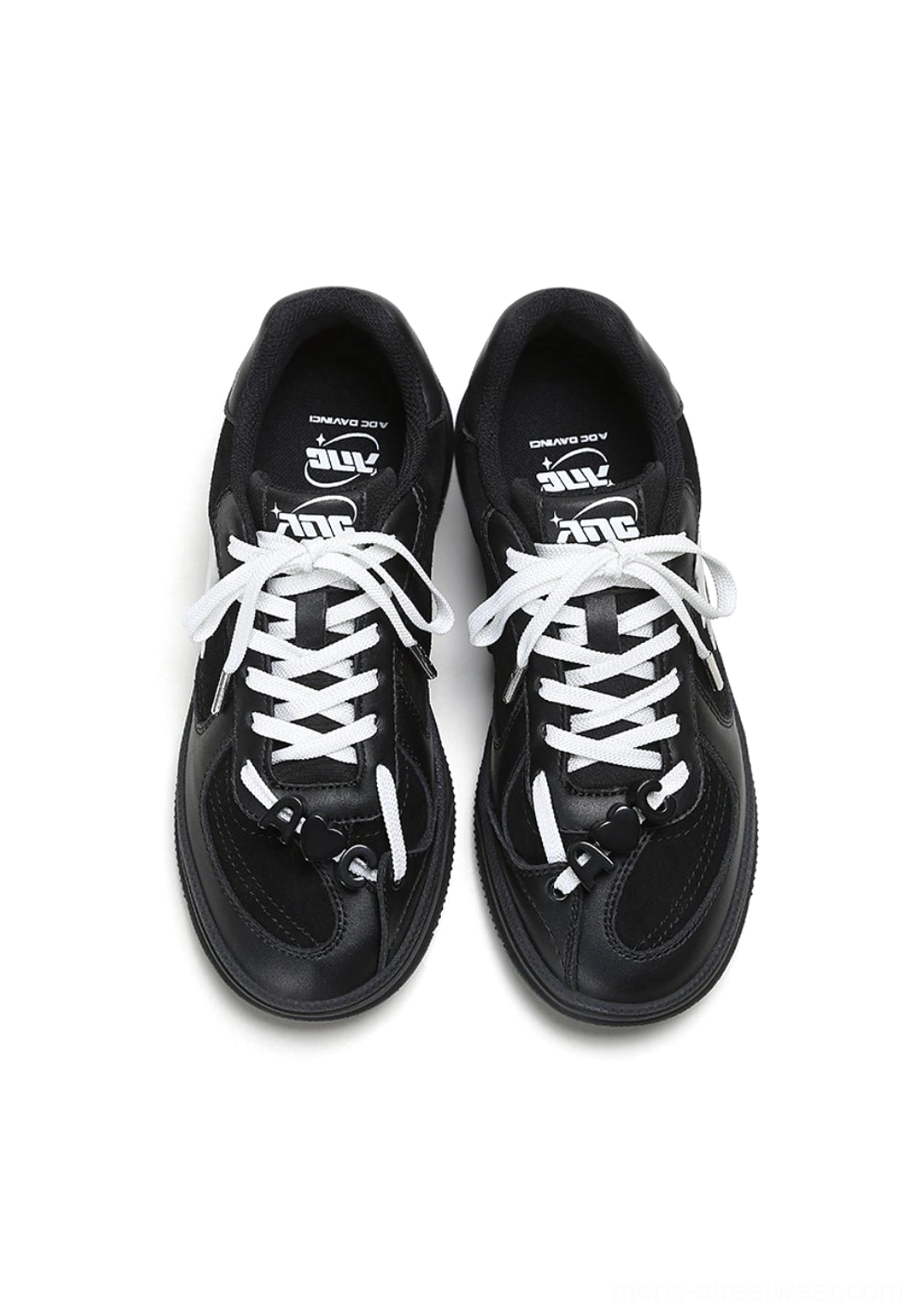 Overhead view of black solar star applique court sneakers with white laces, lace charms, and graphic insoles