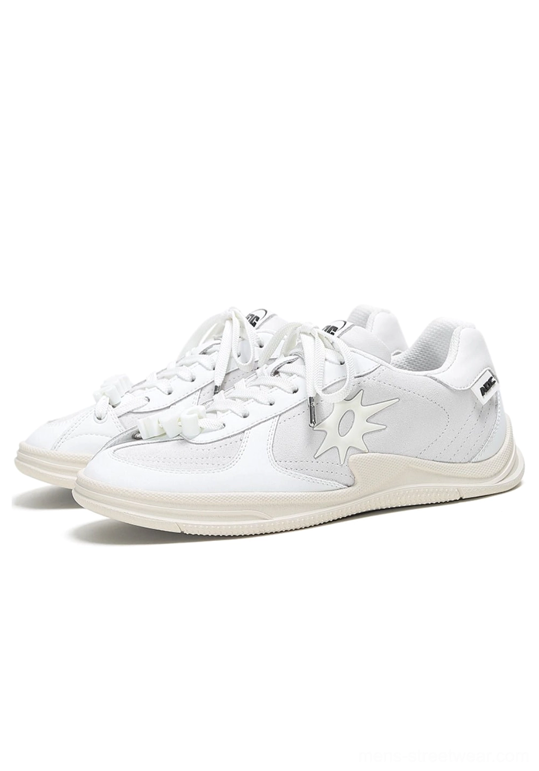 Solar star applique black and white court sneakers showing the low-top unisex streetwear silhouette