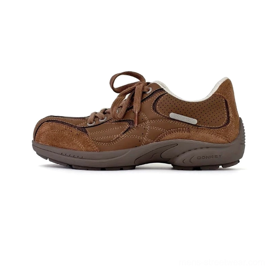 Solid brown retro running sneakers with suede-style upper, flat waxed laces, minimal contrast stitching, and textured rubber outsole
