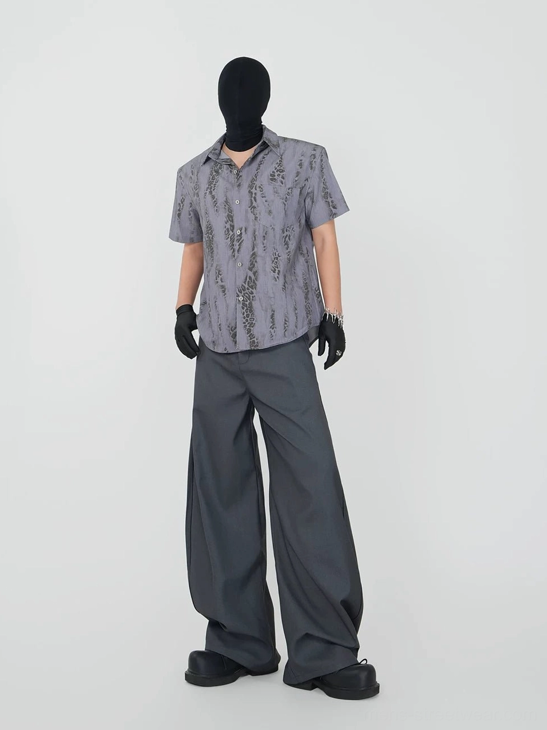 Front view of solid grey ultra-wide dress trousers with clean front pockets, belt loops, and a dramatic avant-garde streetwear silhouette