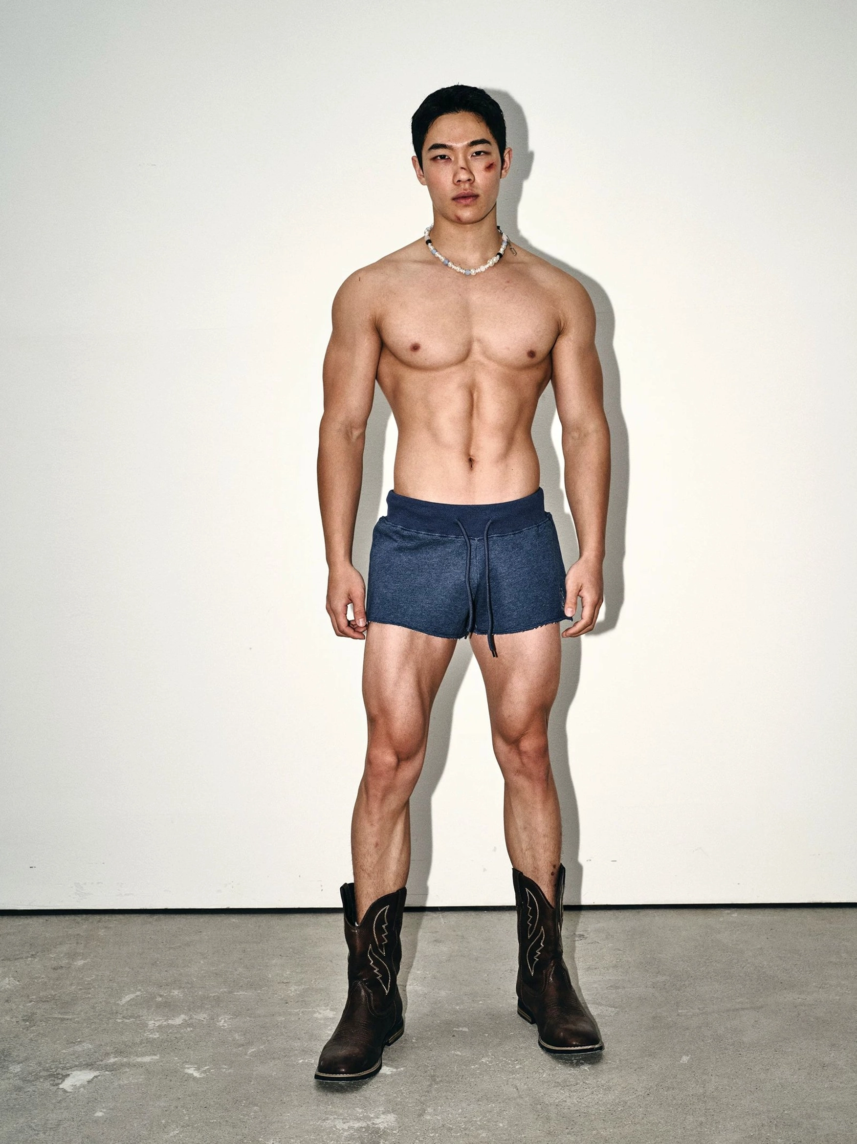Full front view of solid indigo blue sweat shorts with elastic drawstring waistband and contemporary Korean streetwear fit