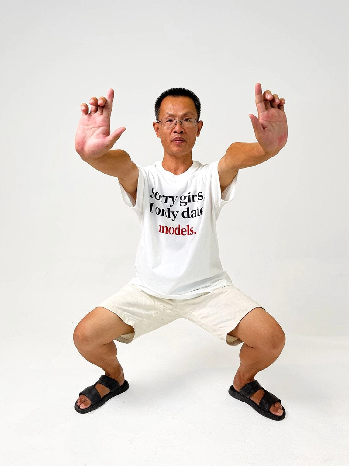White oversized Sorry Girls I Only Date Models T-shirt styled with white shorts and black slides