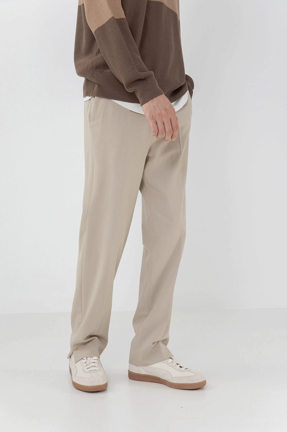 Lower body side view beige split hem straight pants brown contrast knit top white casual shoes