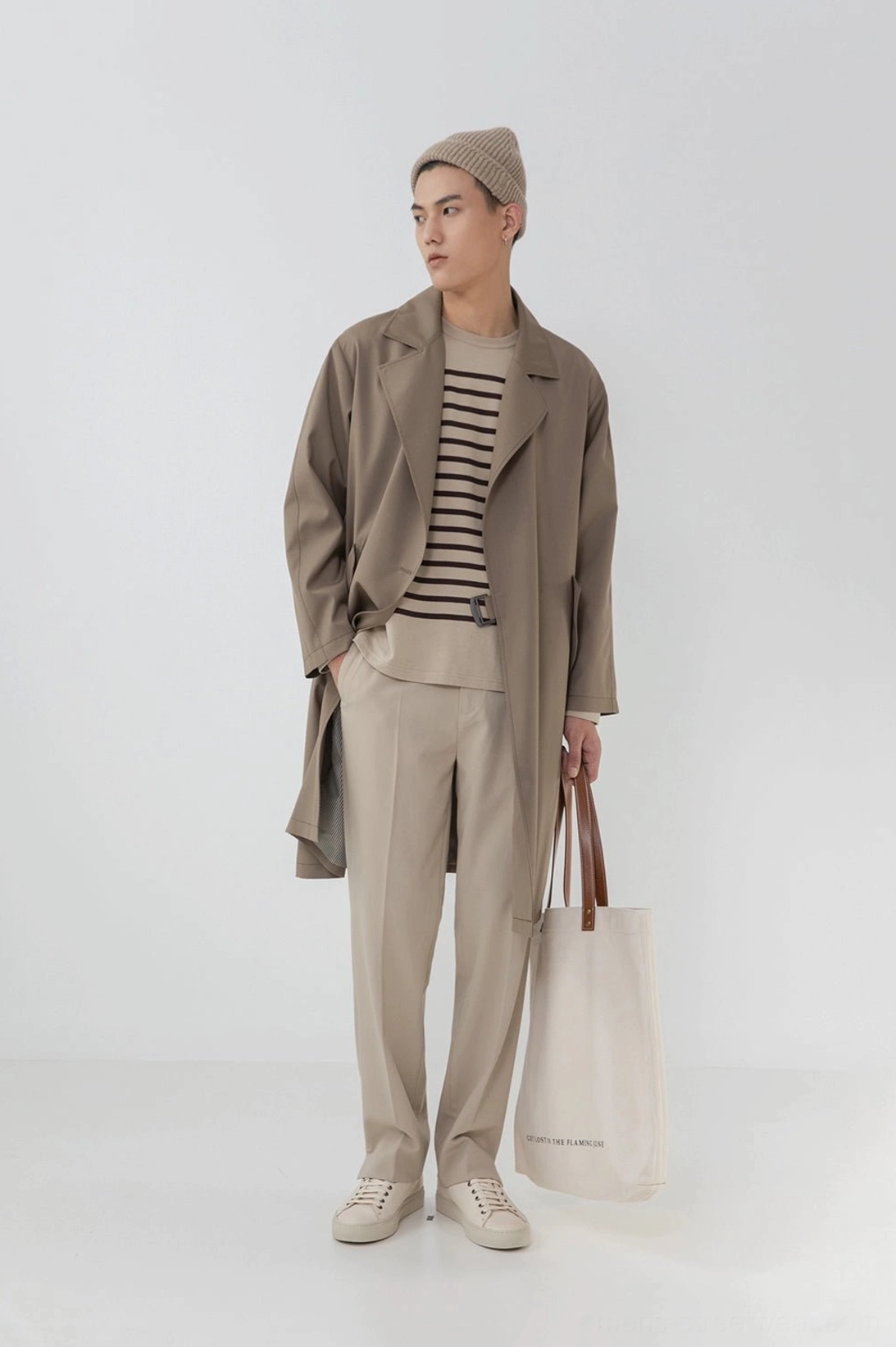 Side profile tailored beige split hem pants loose long coat layered outfit minimalist studio