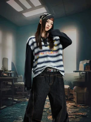 Star graphic striped rugby tee with contrast black sleeves worn by female model in a vintage streetwear outfit