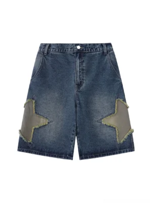 Front flat lay view of washed dark blue star patch denim shorts with frayed grey star appliques on both thighs and classic button fly closure
