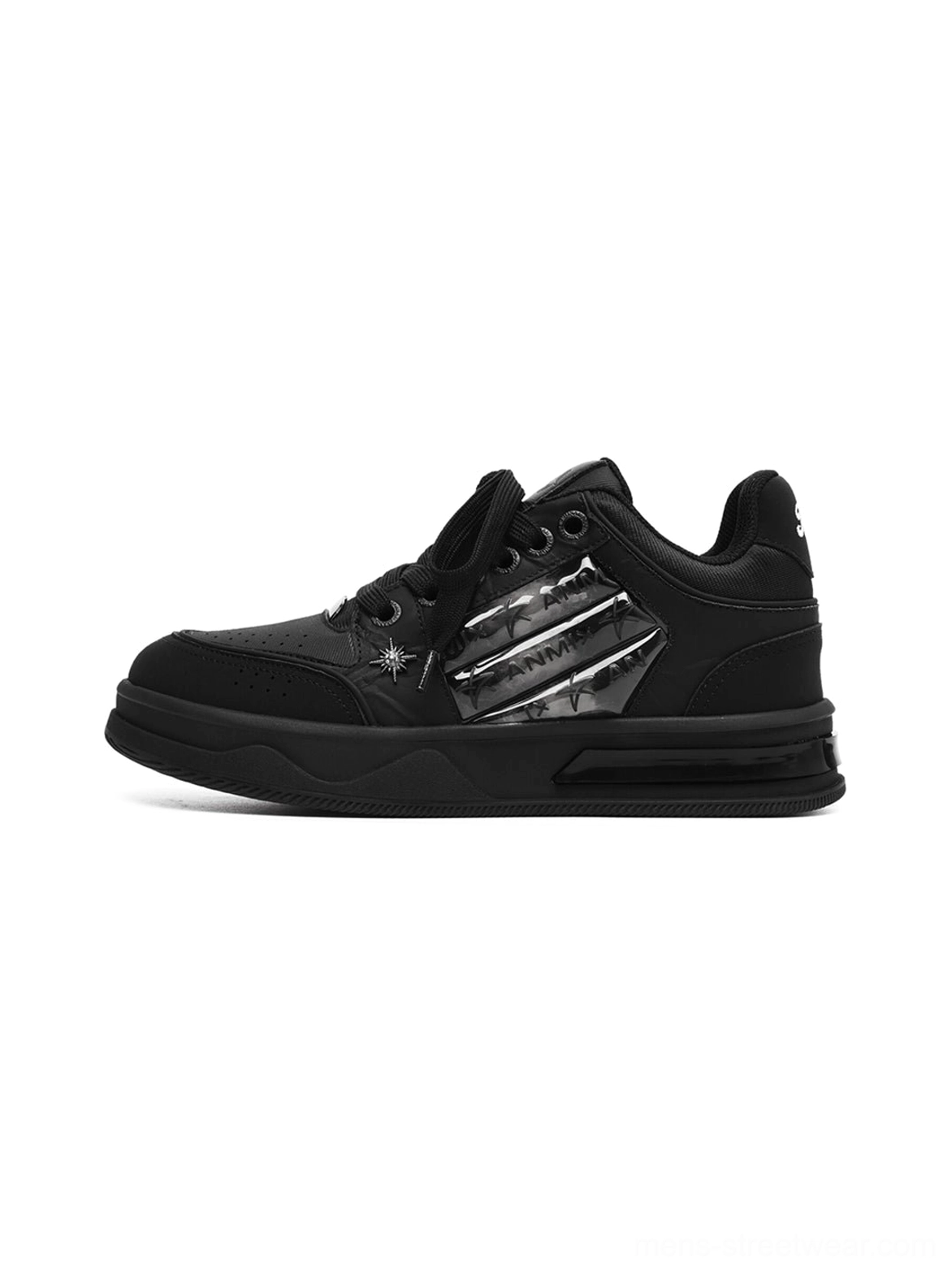 Star studded gothic black sneakers with silver side panels and chunky platform rubber soles shown in side profile